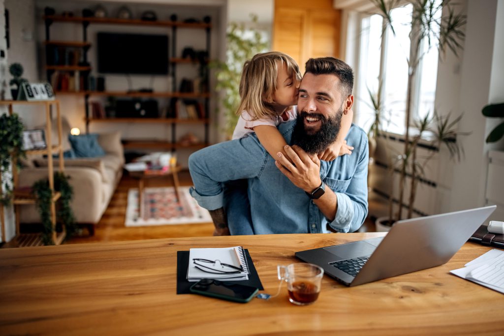 man holding daughter around shoulders